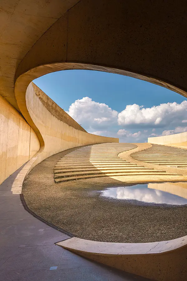 Curved concrete architecture under a blue sky